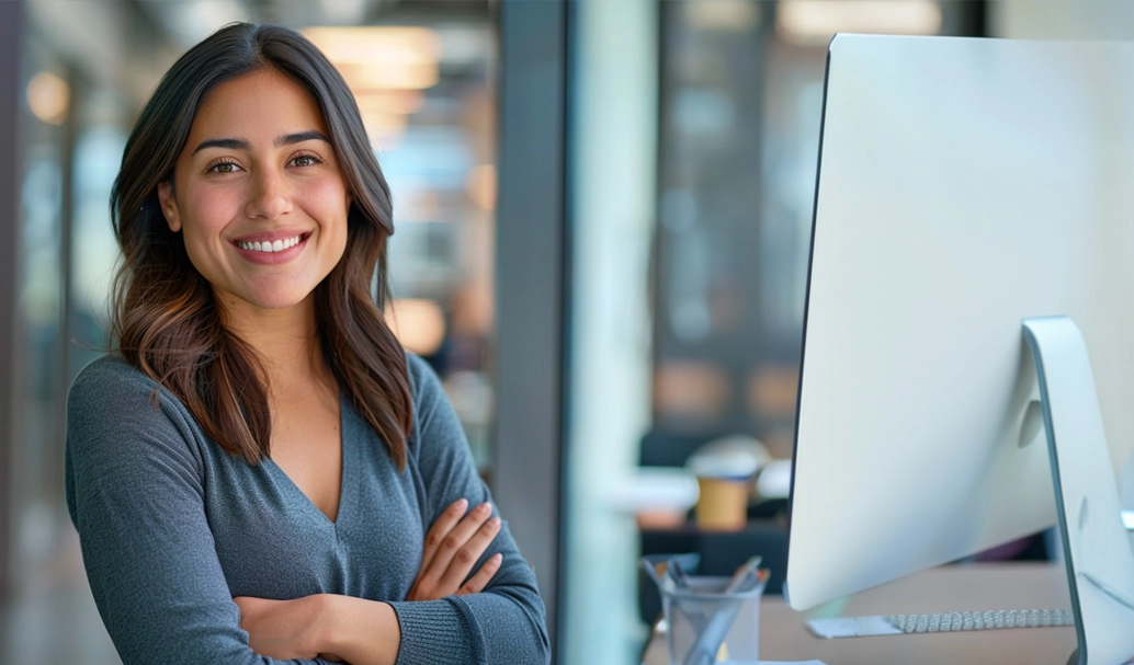 Woman standing with her arms crossed while smiling