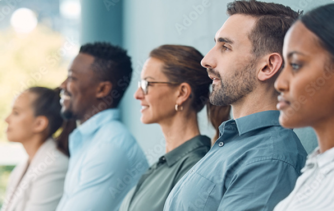 Three people in their 20s standing in front of a blue wall